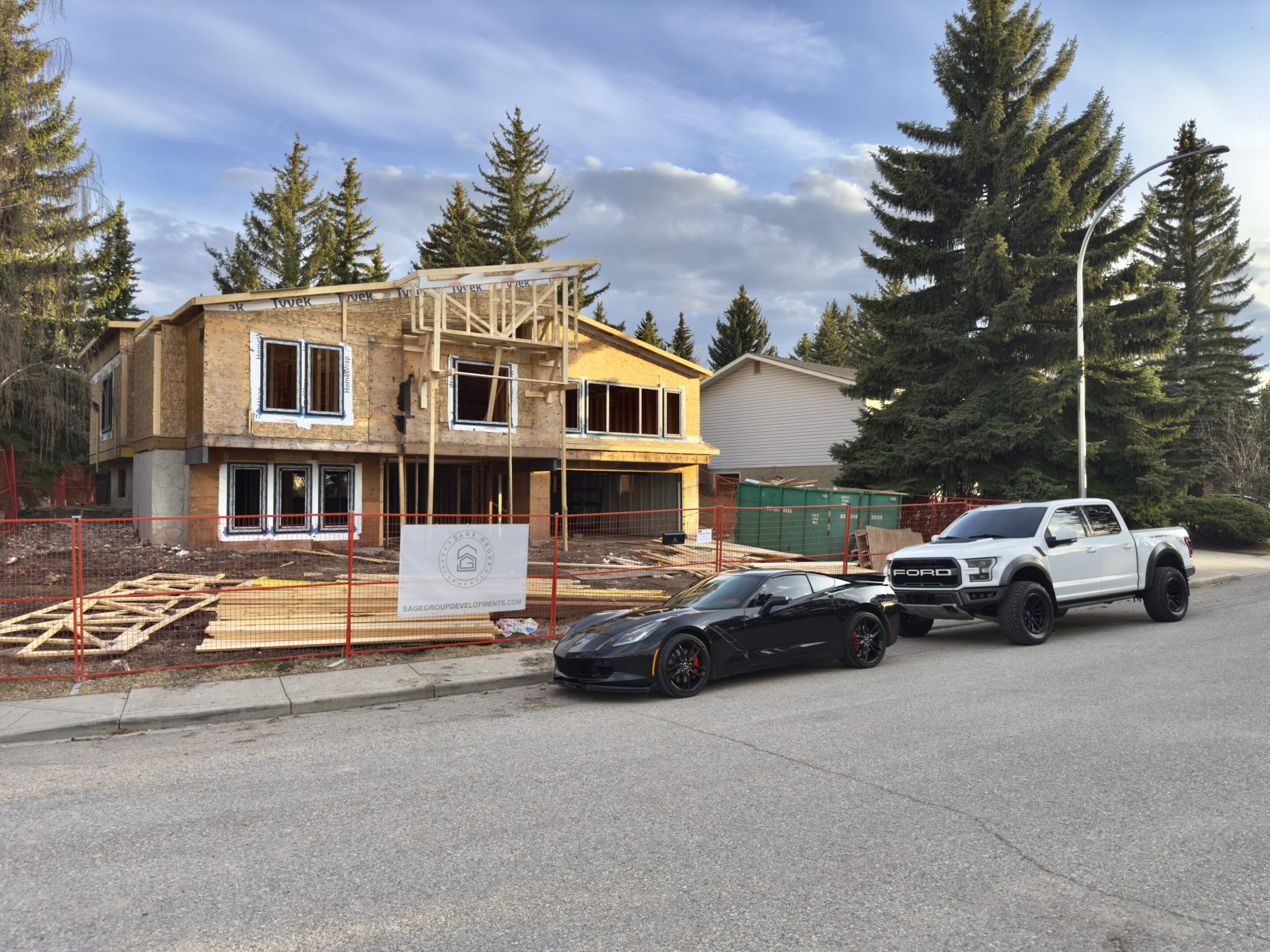 A house that is being built on the side of a road.