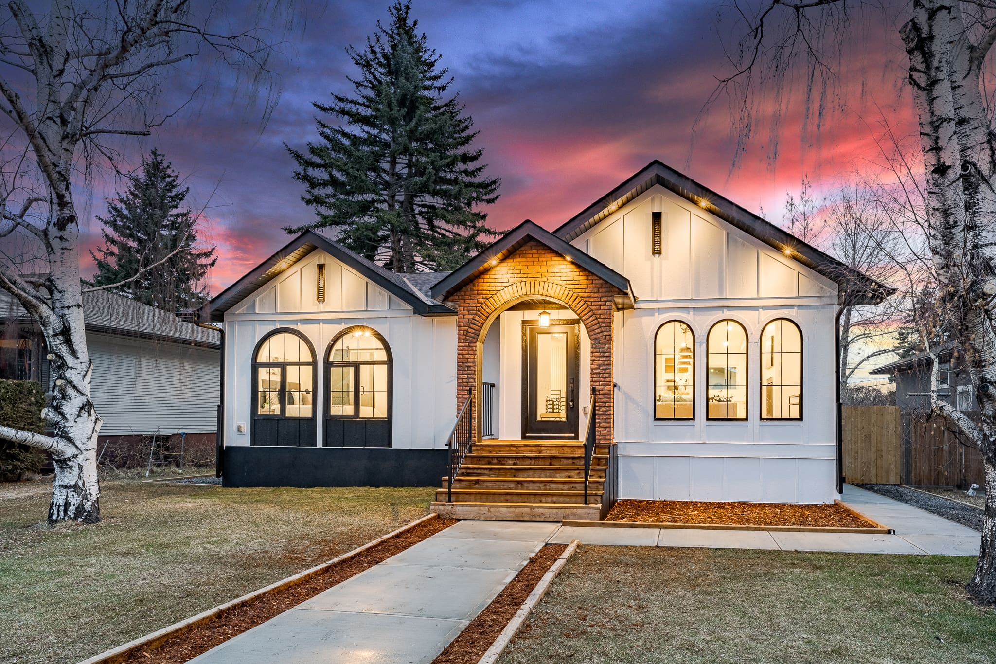 A house with two windows and a porch.