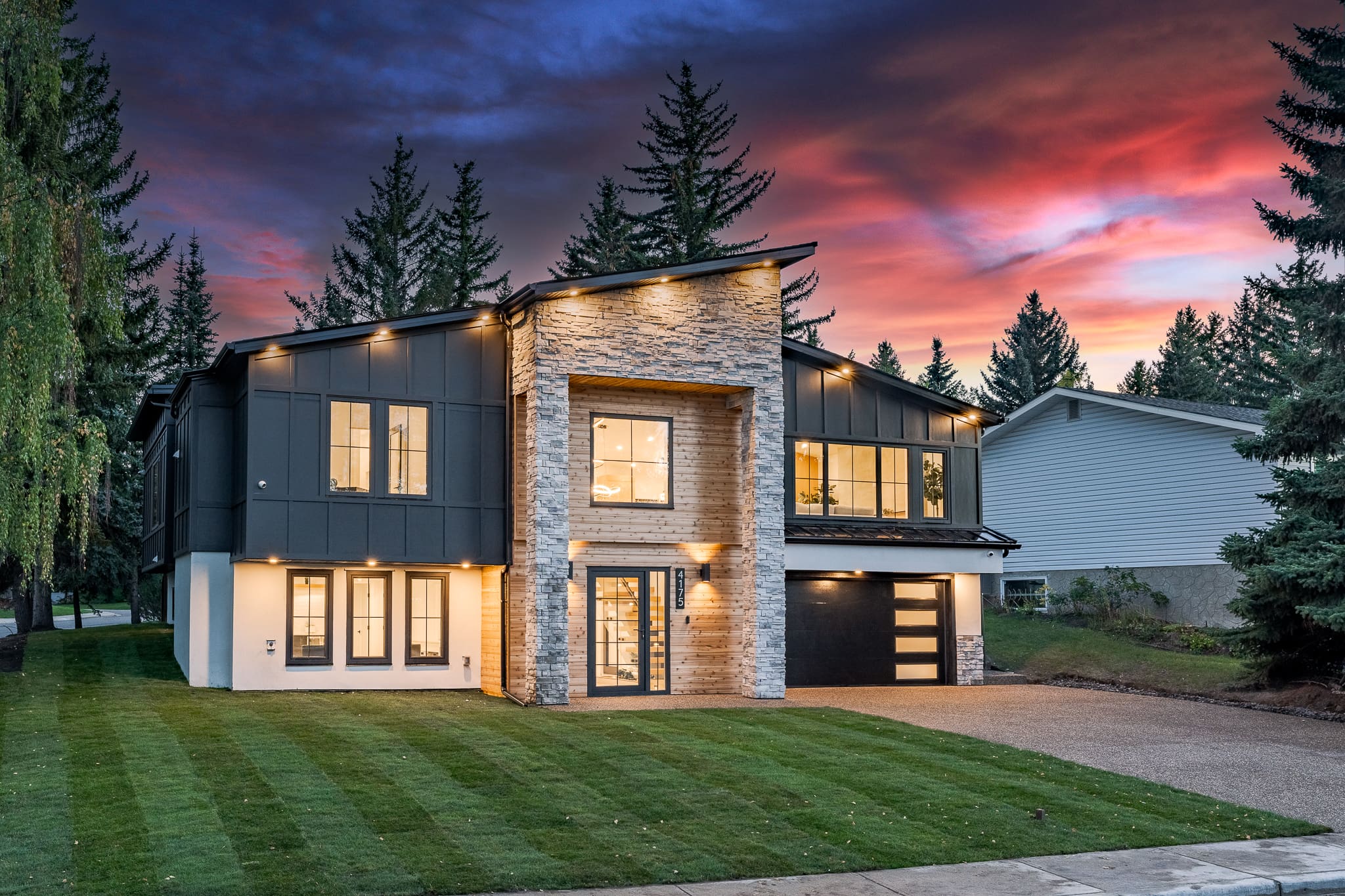 A large house with lights on the outside of it.