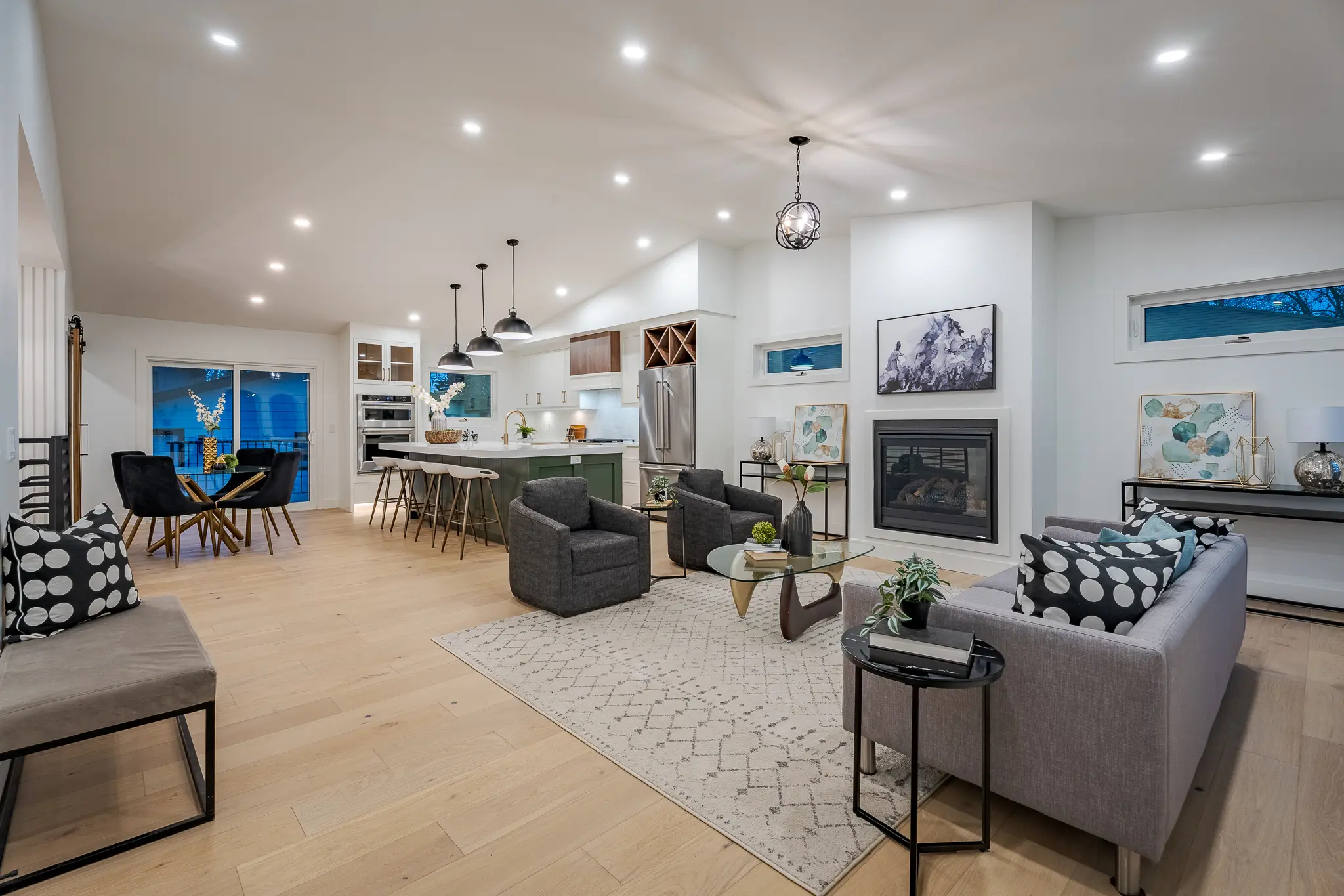 A living room with a fireplace and a large open floor plan.