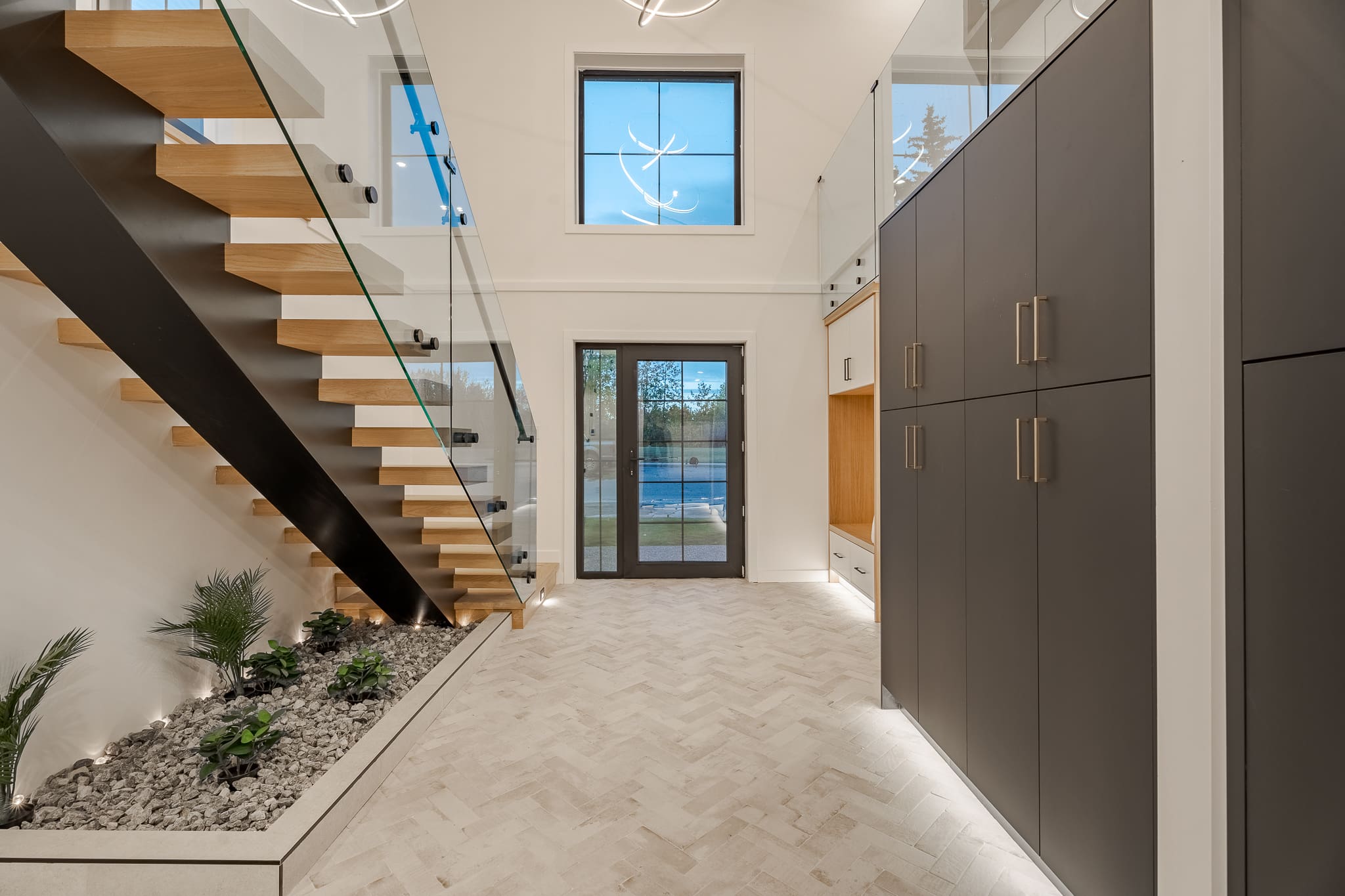 A large open floor plan with a glass staircase.