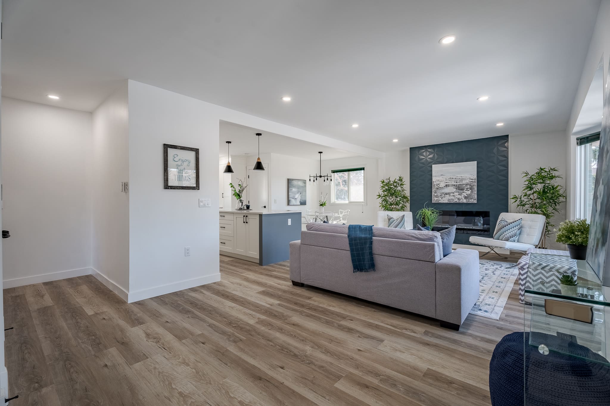 A living room with hard wood floors and white walls.