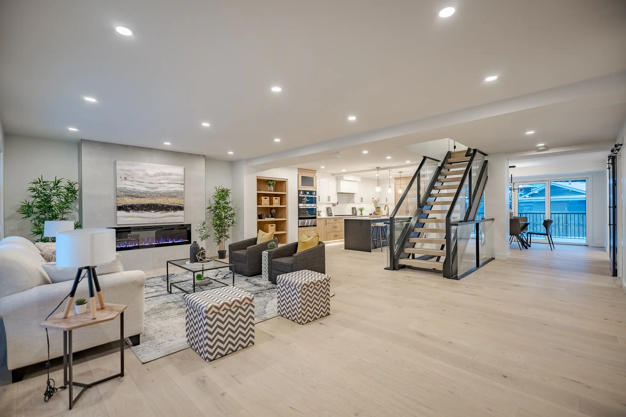 A living room with stairs and furniture in it