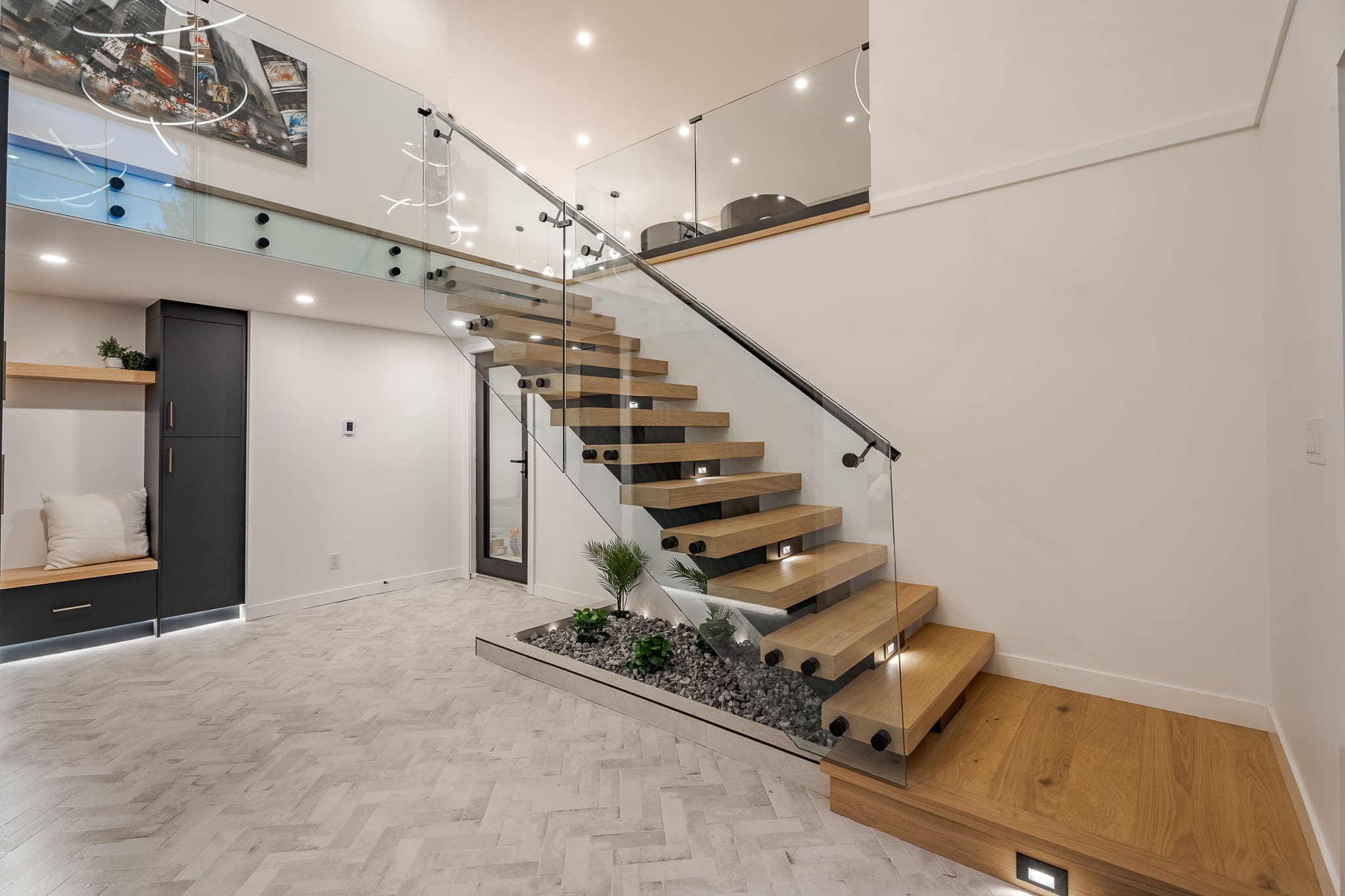 A staircase with glass railing and wood steps.