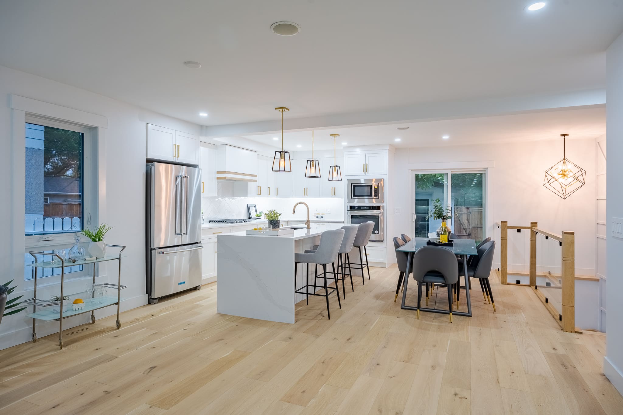 A kitchen with a table and chairs, and a dining room.