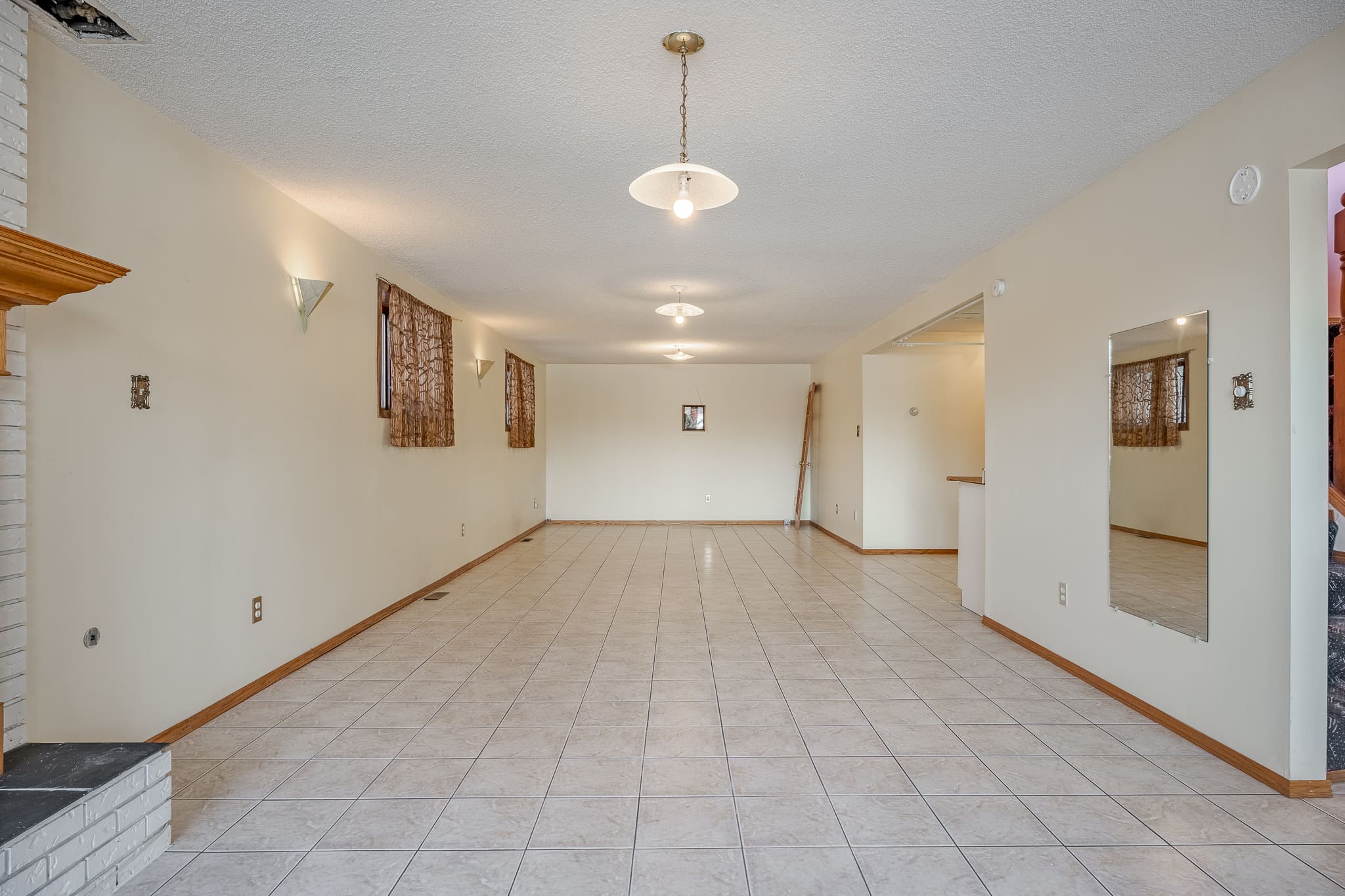 A large room with white tile floors and walls.