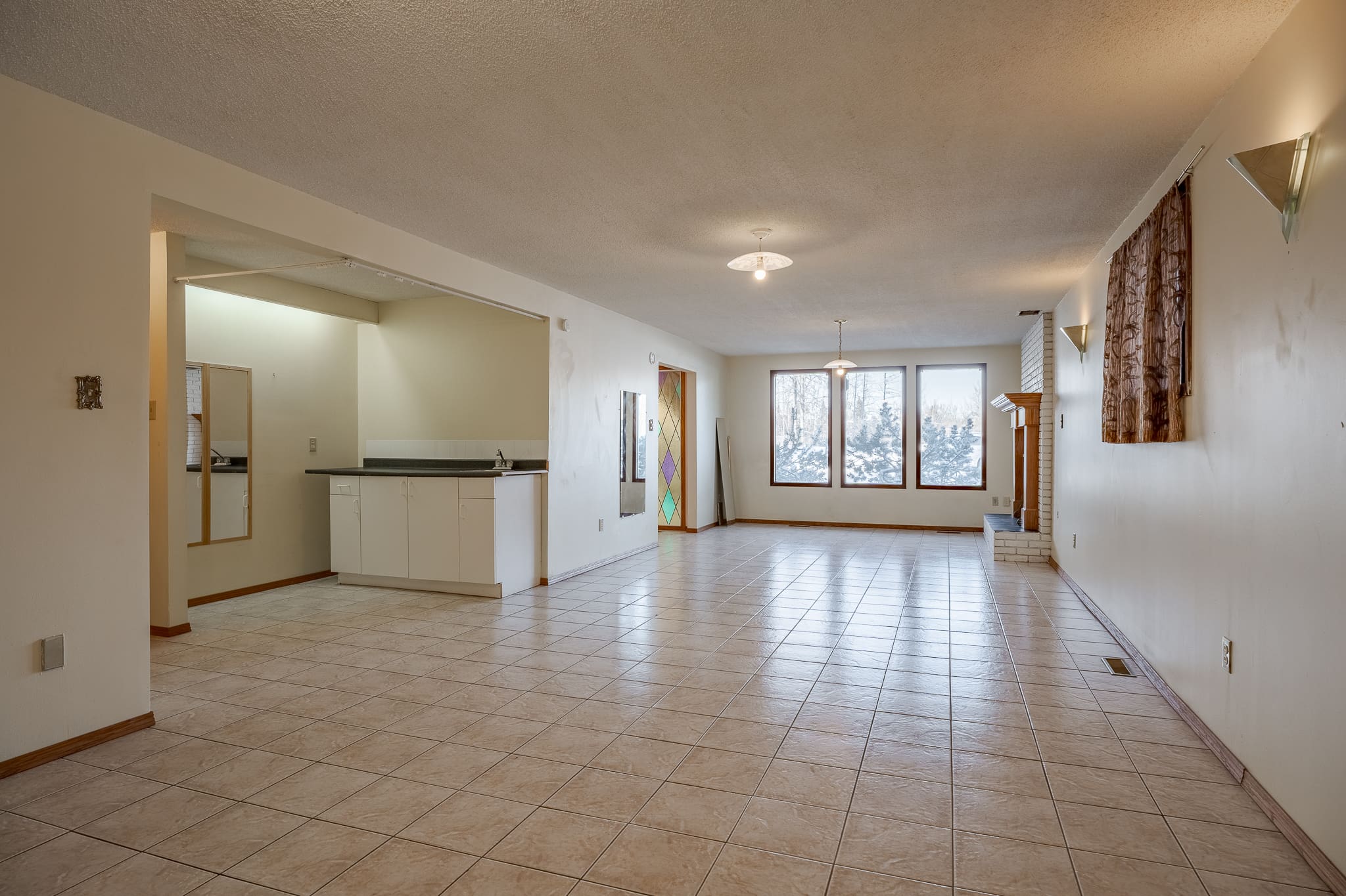 A large room with tile floors and white walls.