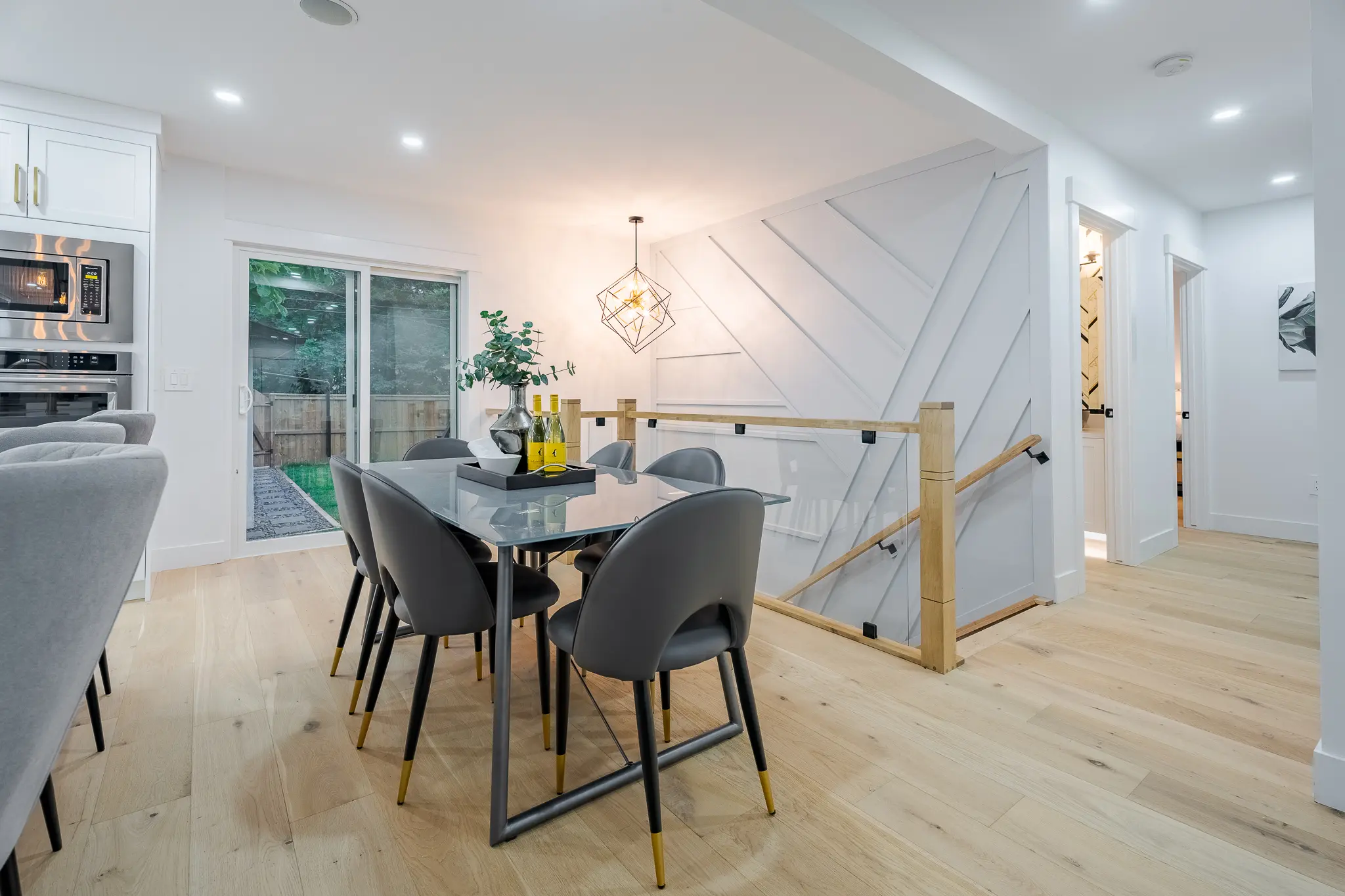 A dining room table with chairs and a glass top.