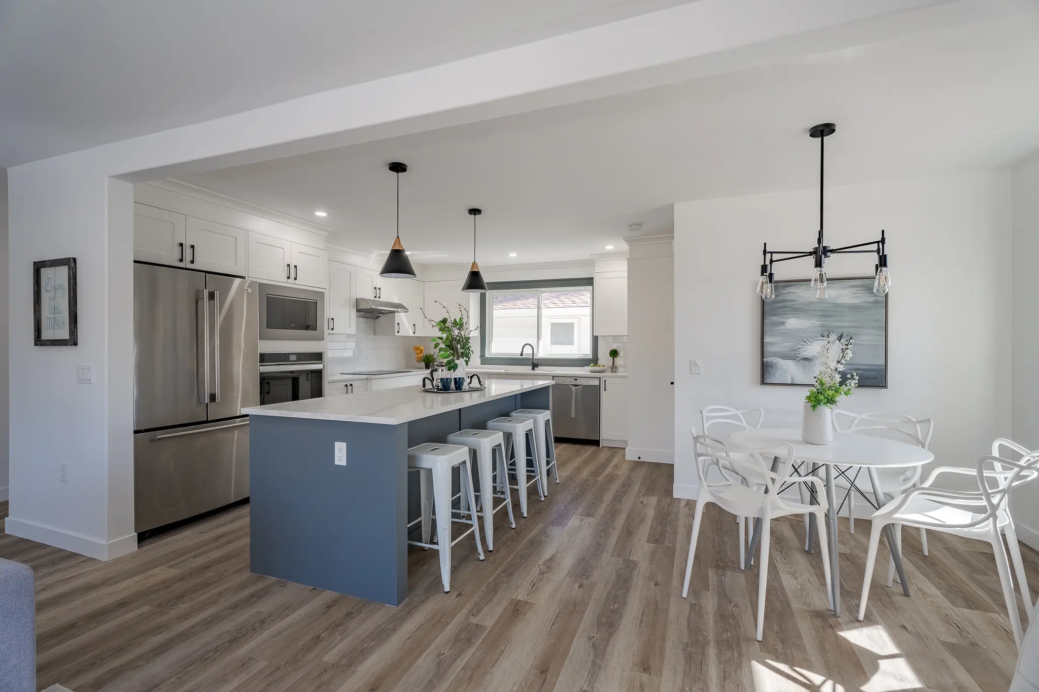 A kitchen with an island and chairs in it