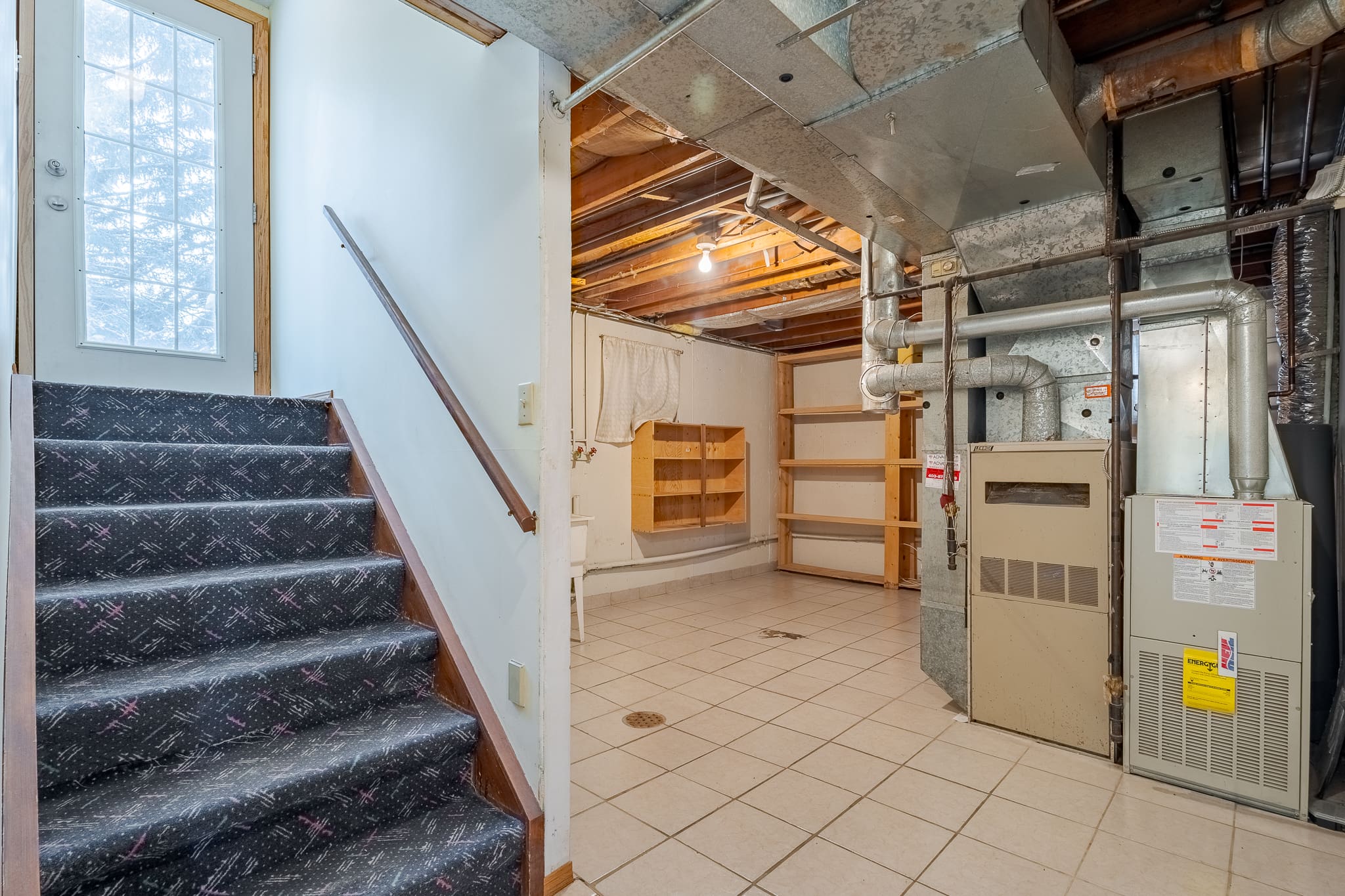 A room with stairs and shelves in it