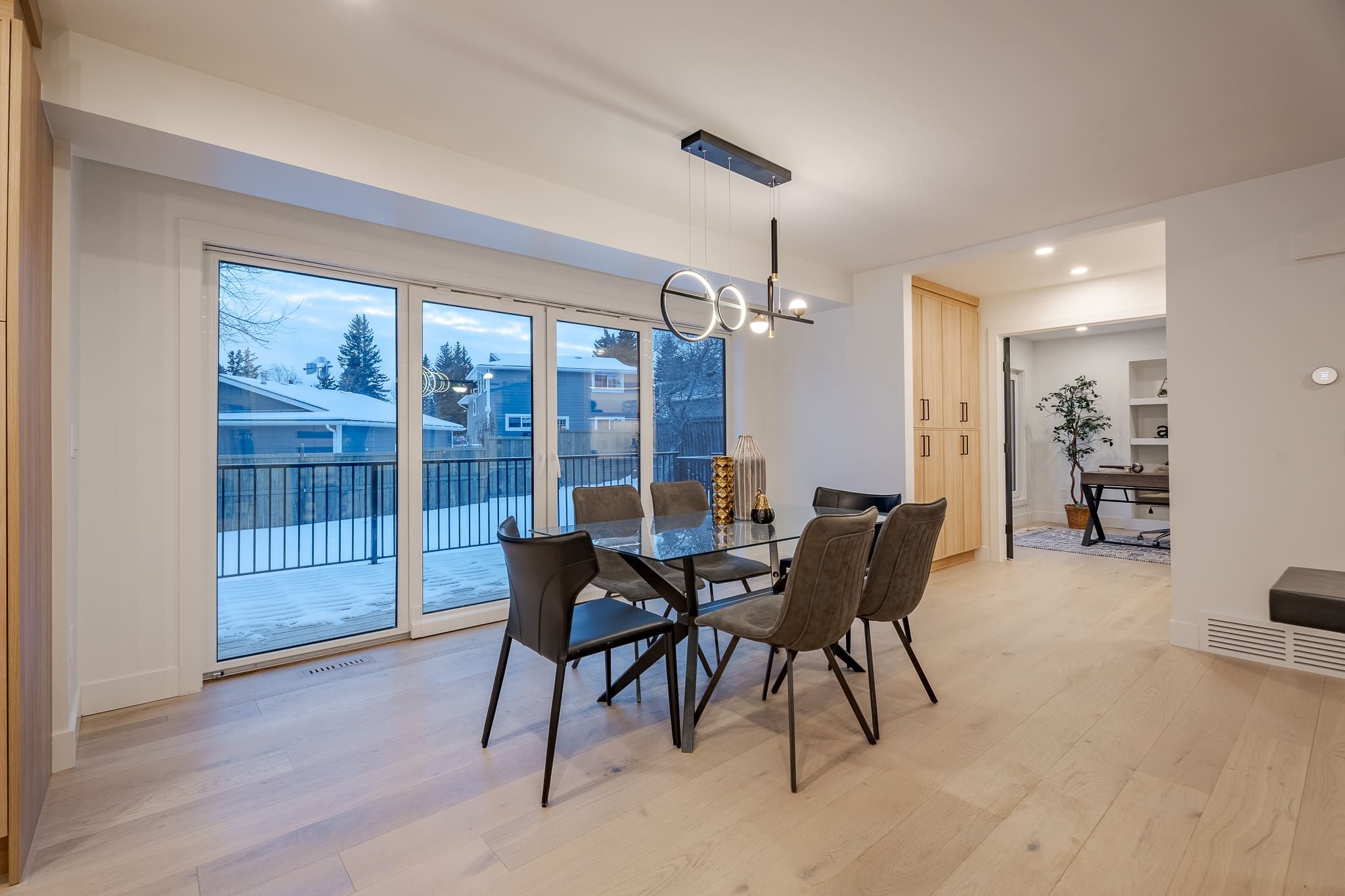 A dining room with a glass table and chairs