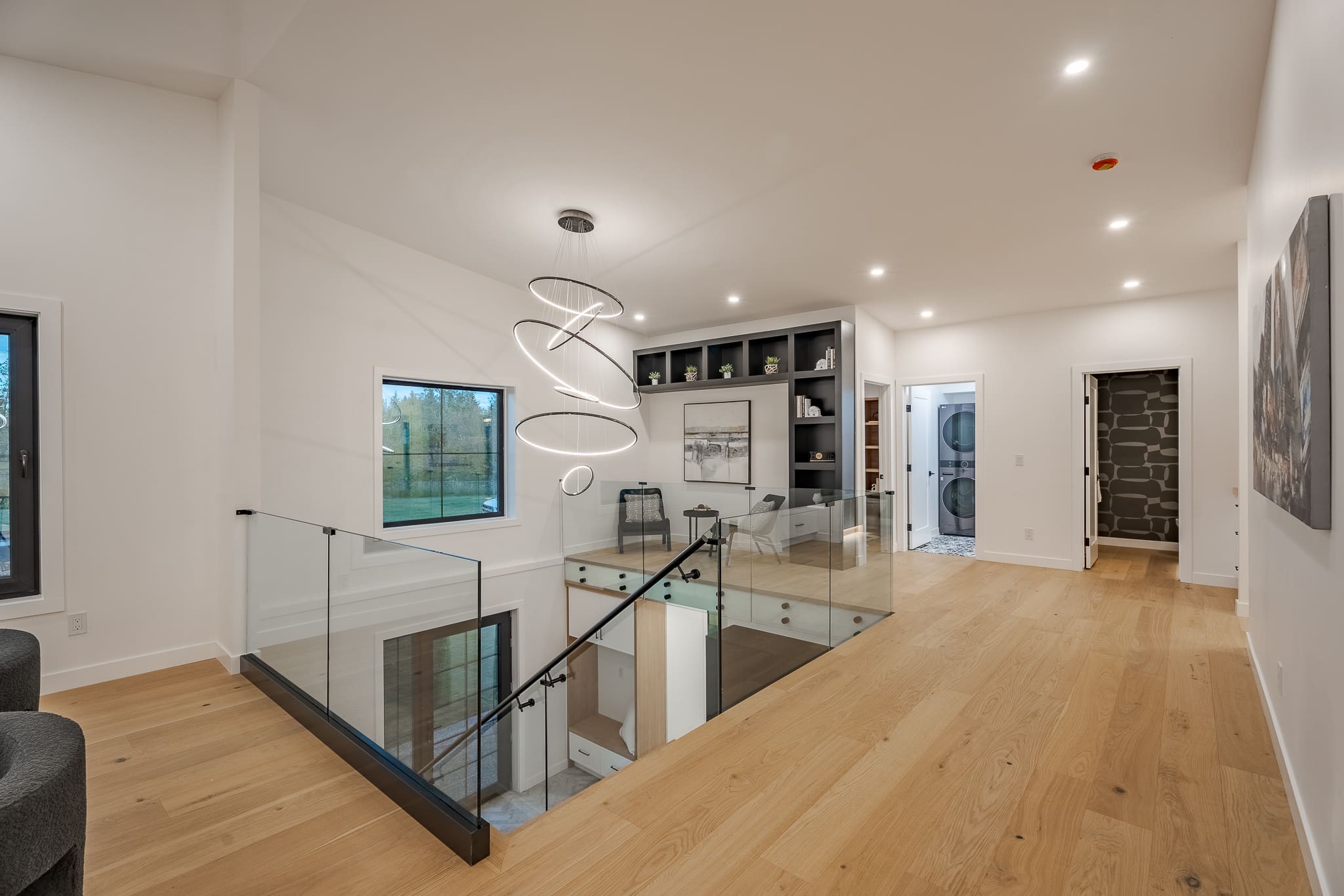 A view of the interior stairs and glass railing.