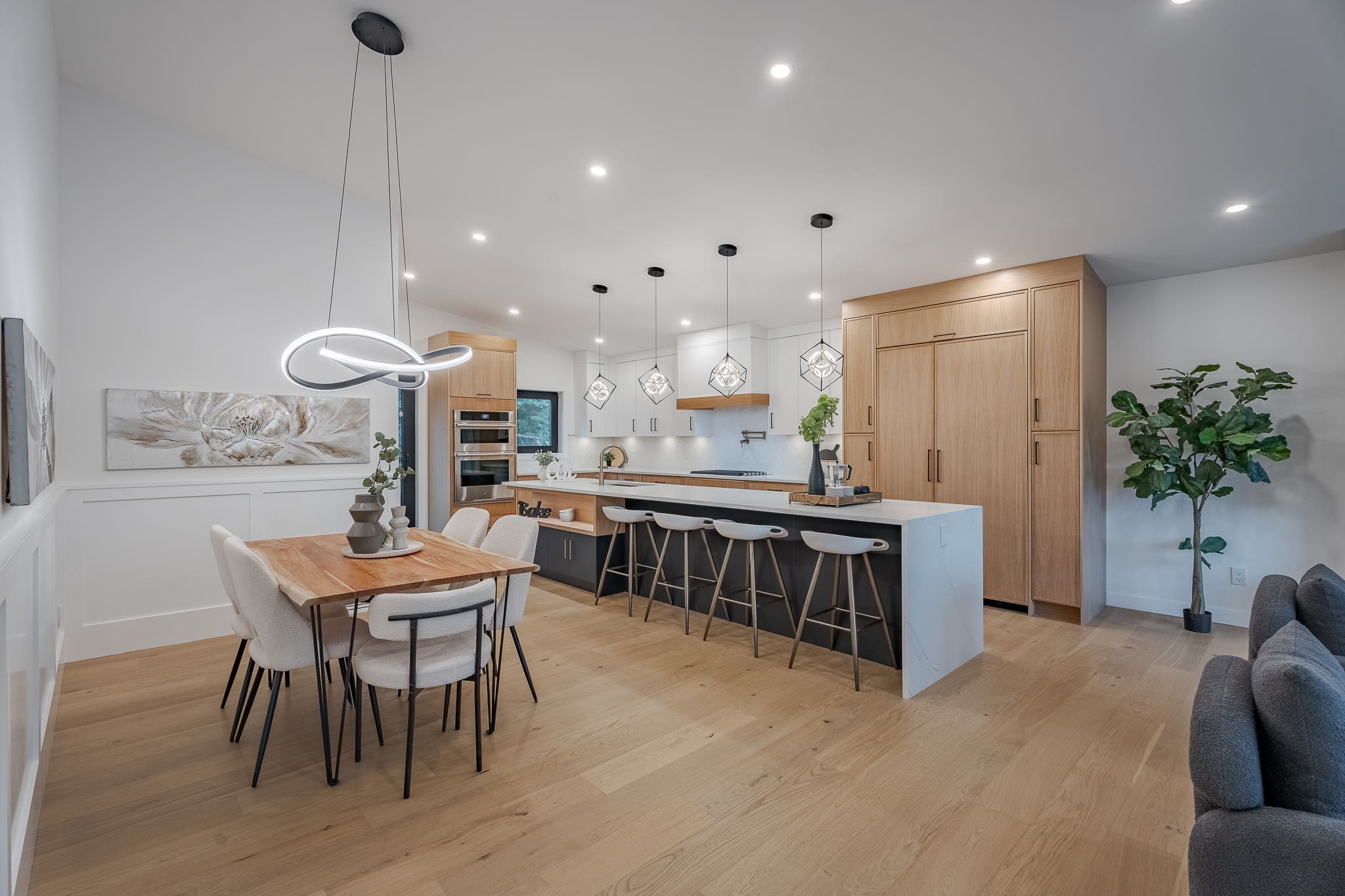 A kitchen with wooden floors and white walls.