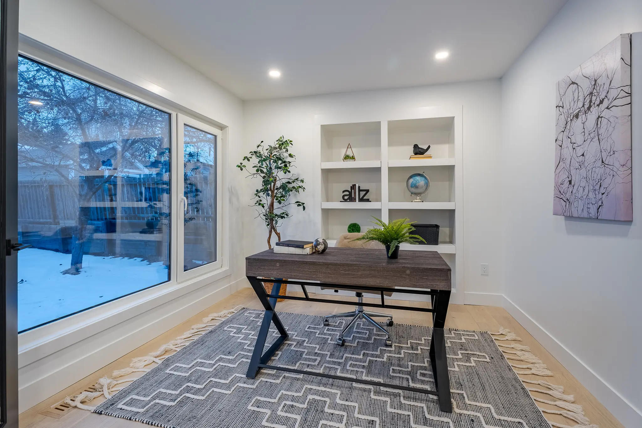 A room with a desk and some shelves in it