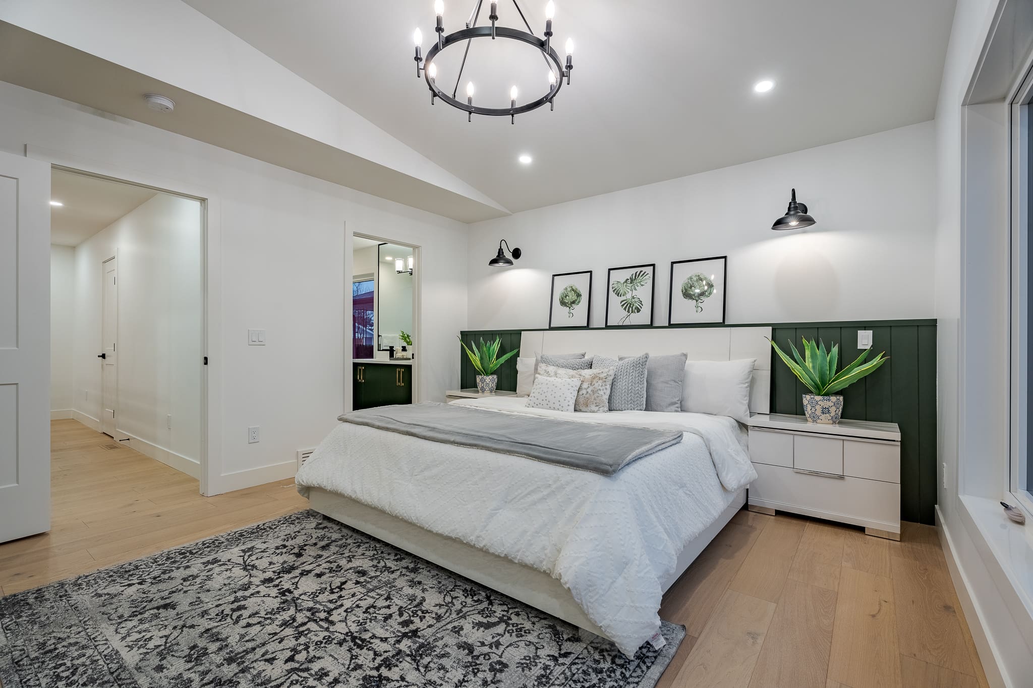 A bedroom with a large bed and white walls.