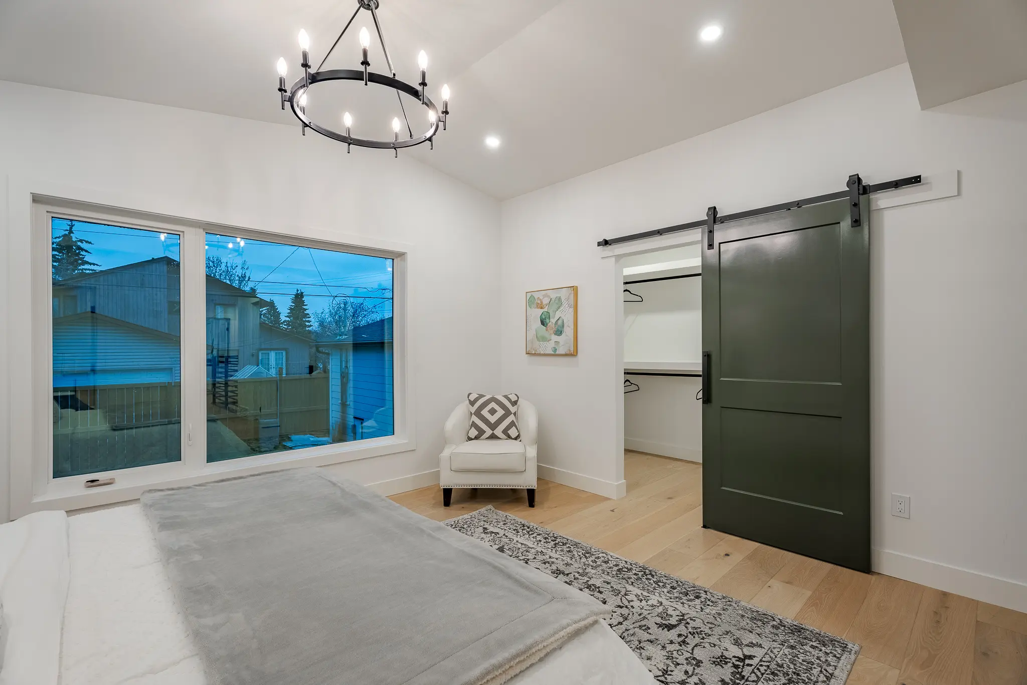 A bedroom with a large sliding glass door.