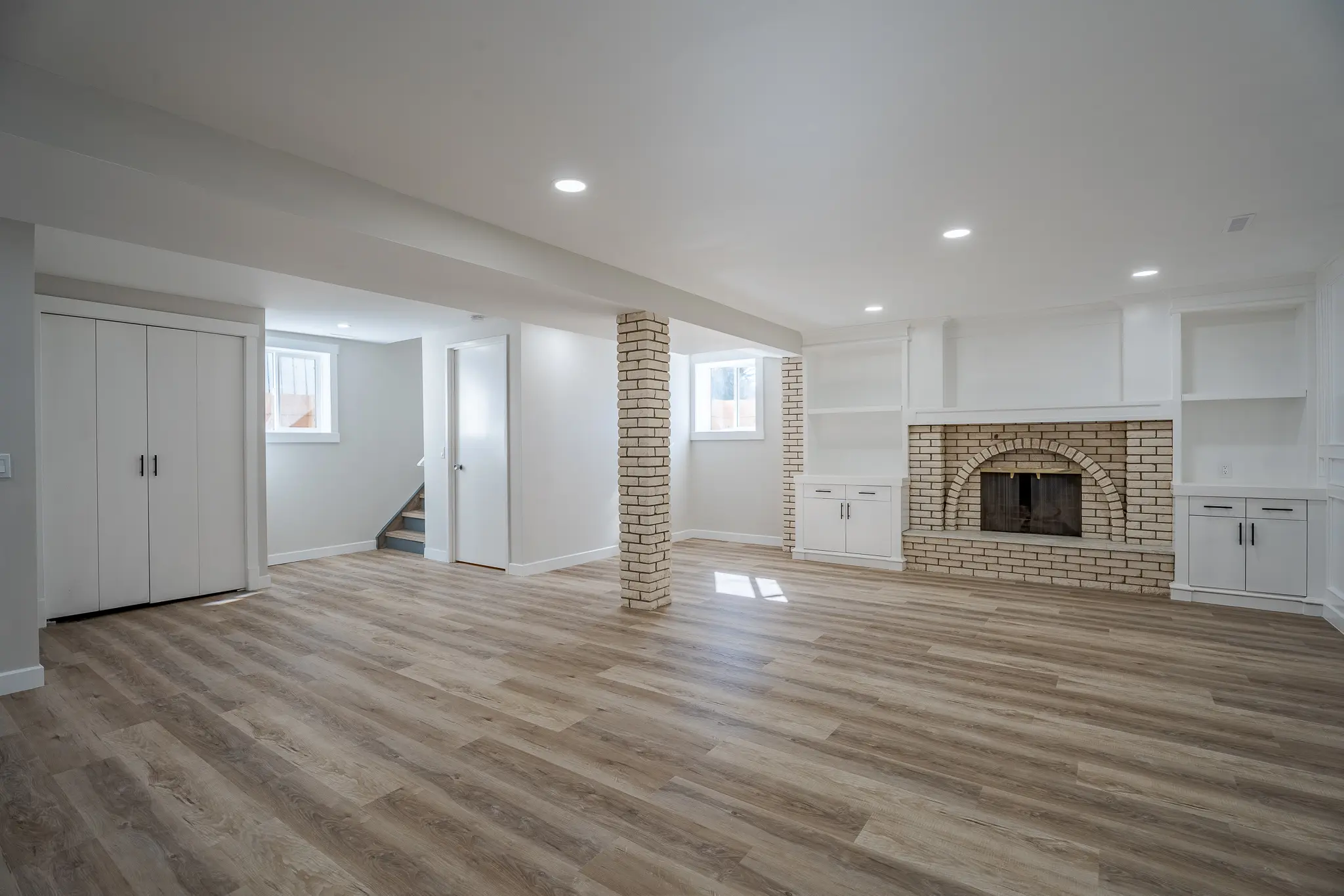 A room with wood floors and white walls.