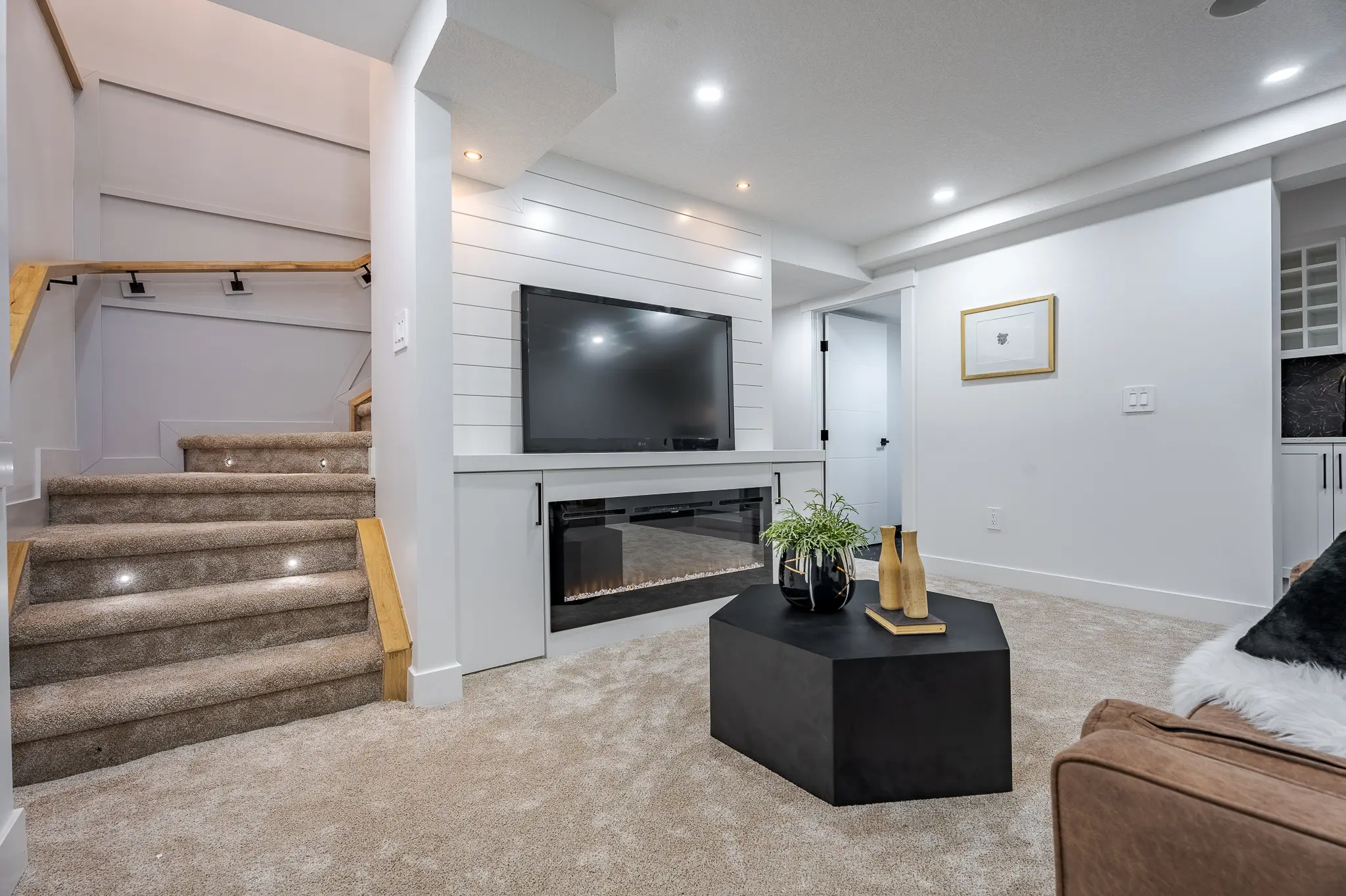 A living room with a fireplace and stairs