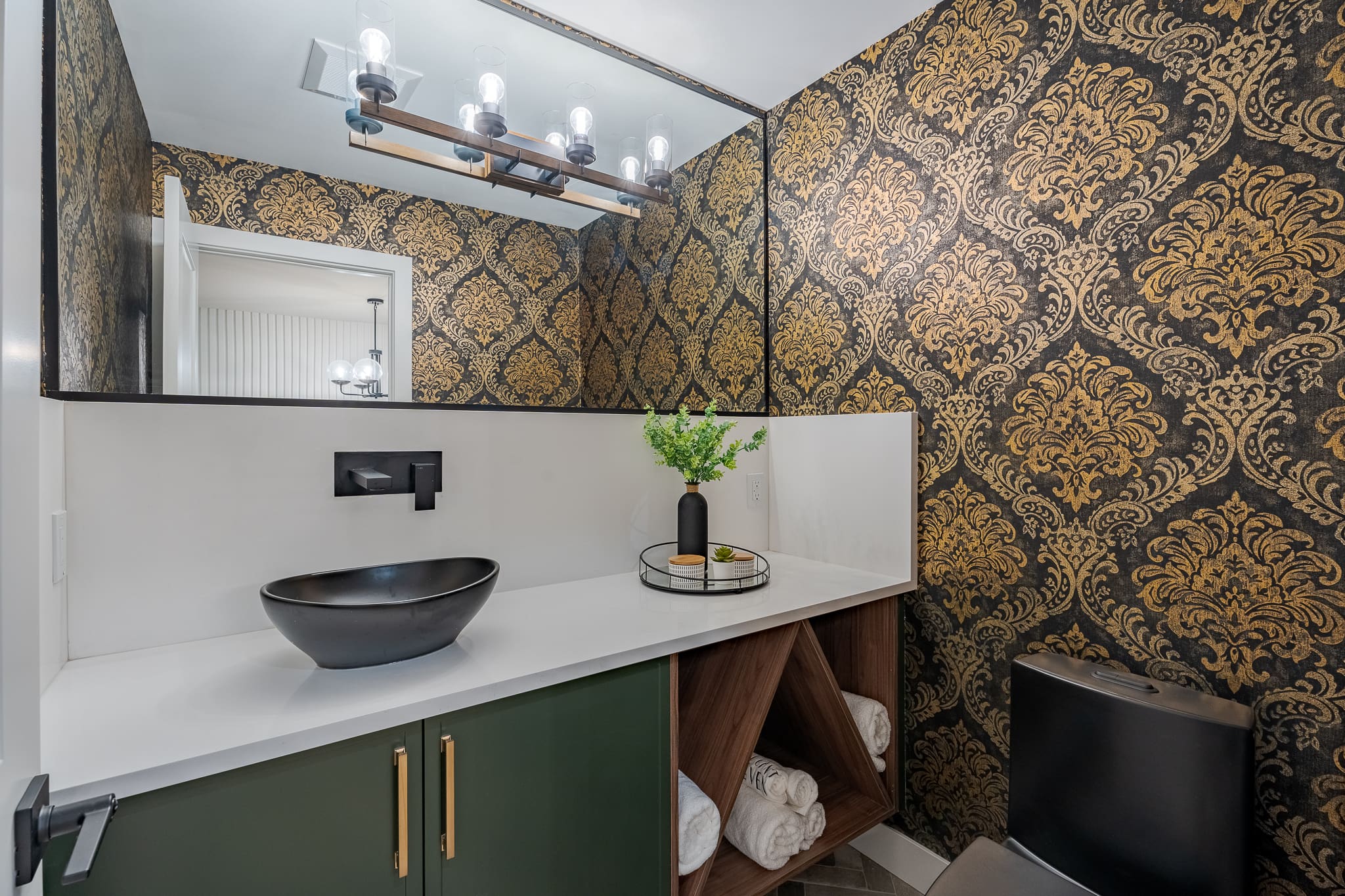 A bathroom with a sink and mirror in it