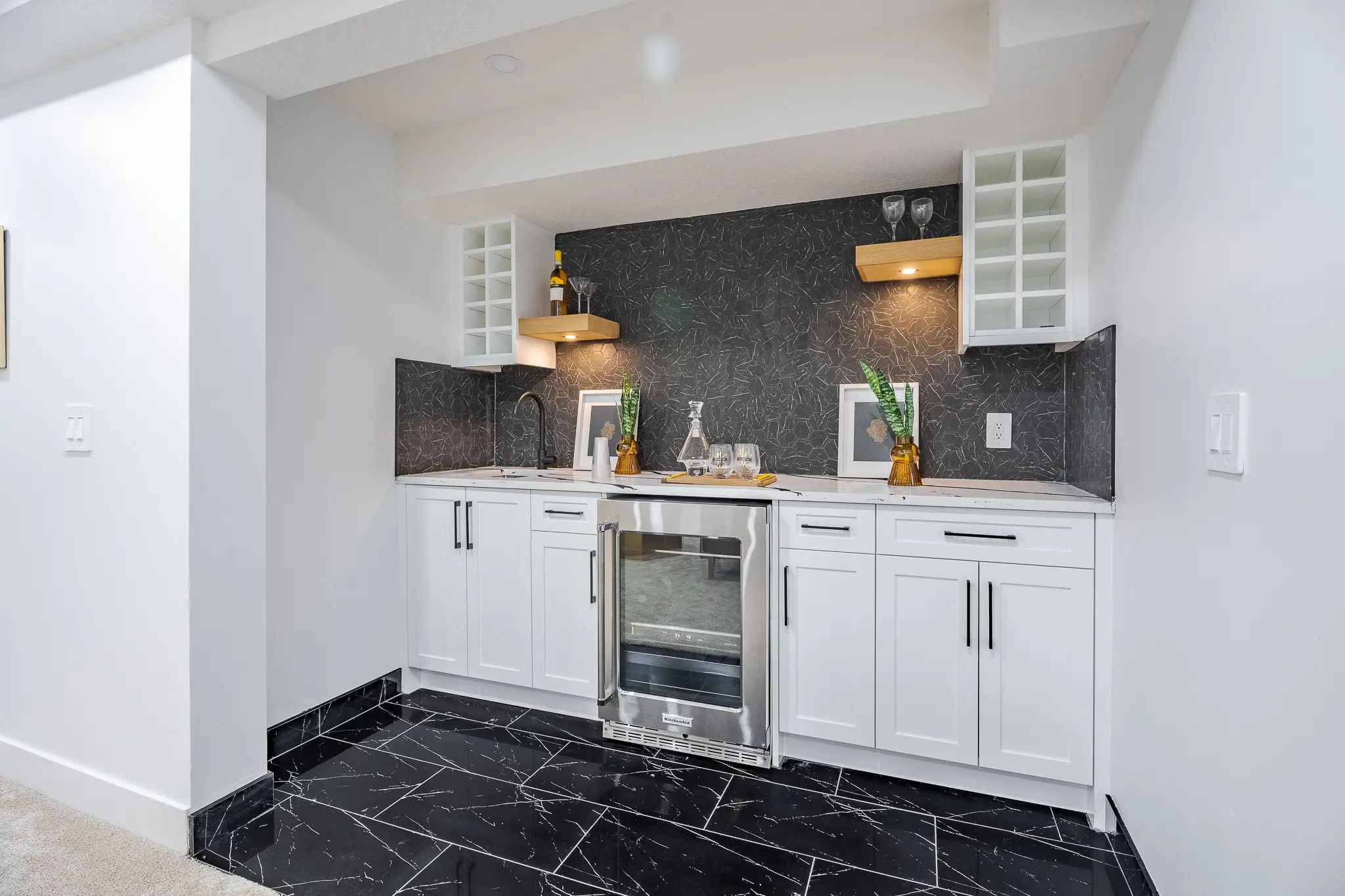 A kitchen with black and white tile floor