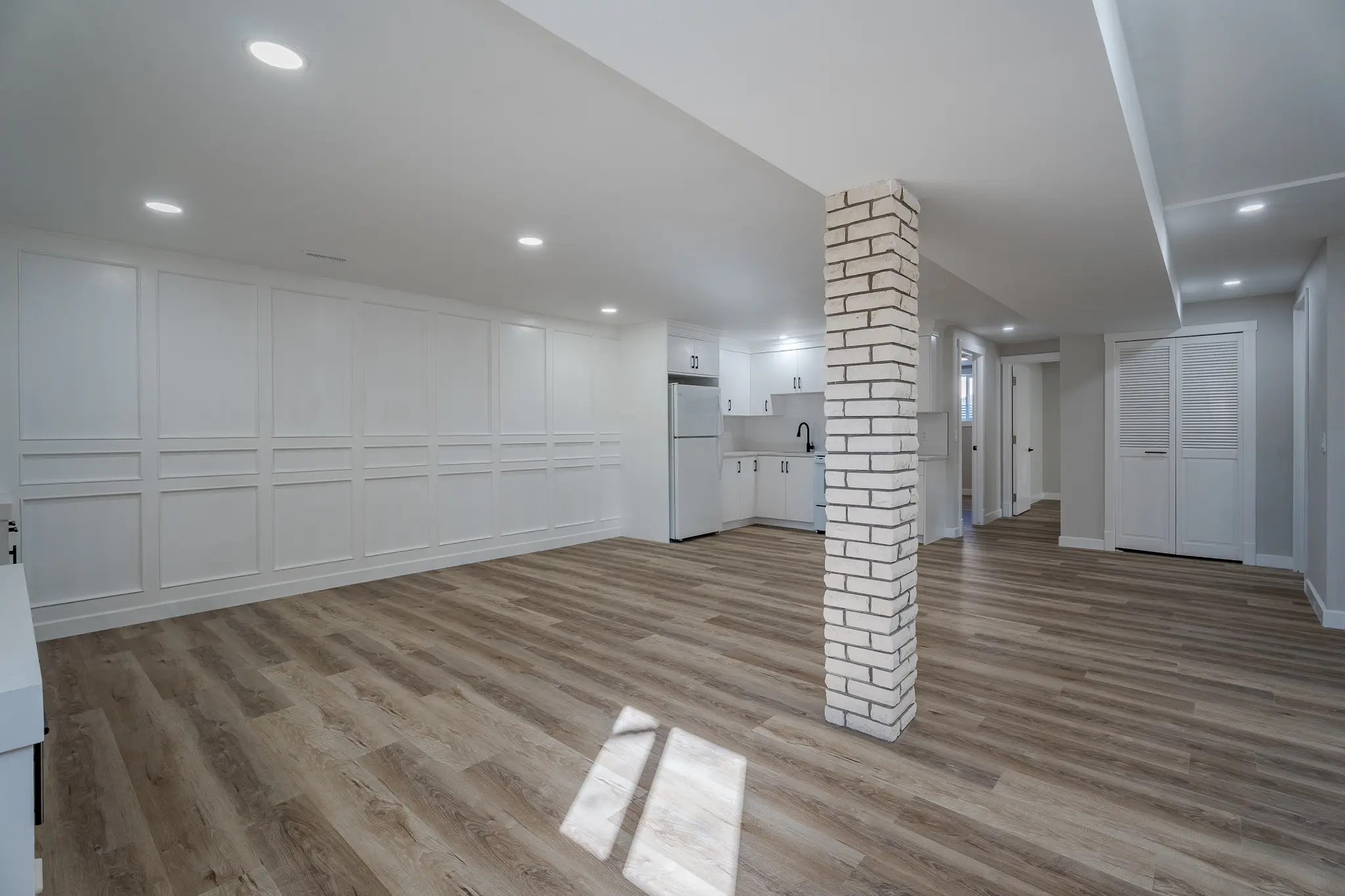 A room with wood floors and white walls.