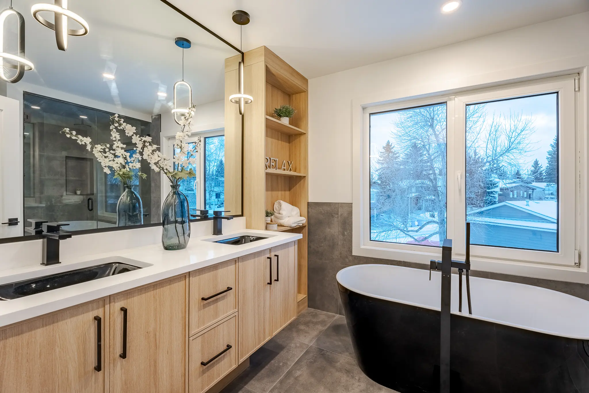 A bathroom with two sinks and a tub.