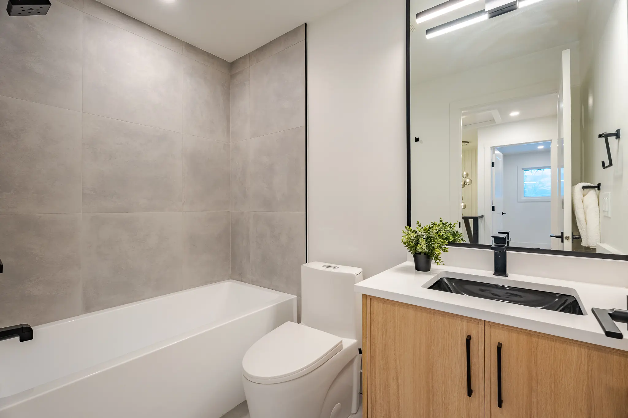 A bathroom with a toilet, tub and sink.