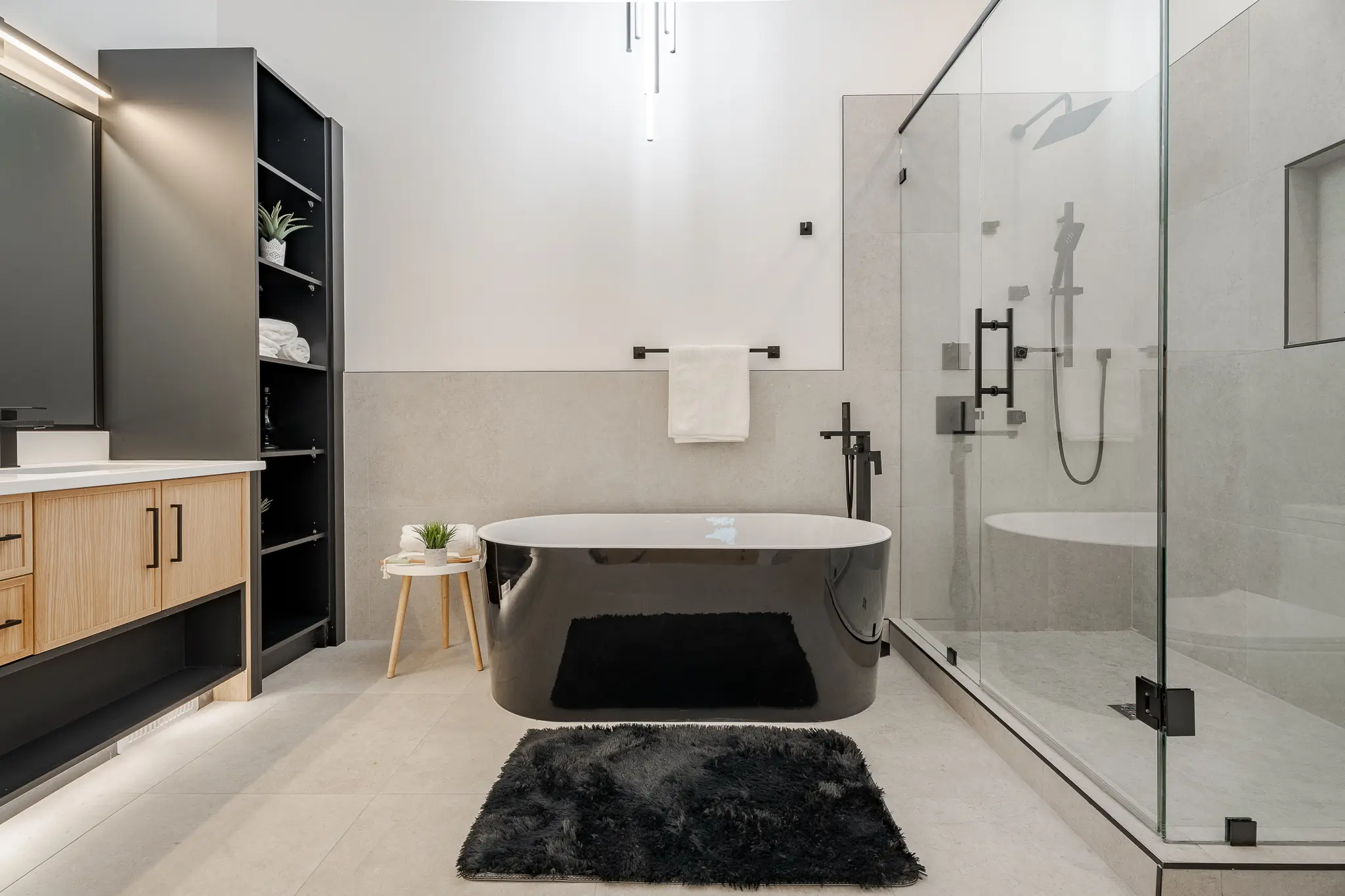 A bathroom with a tub, shower and rug.