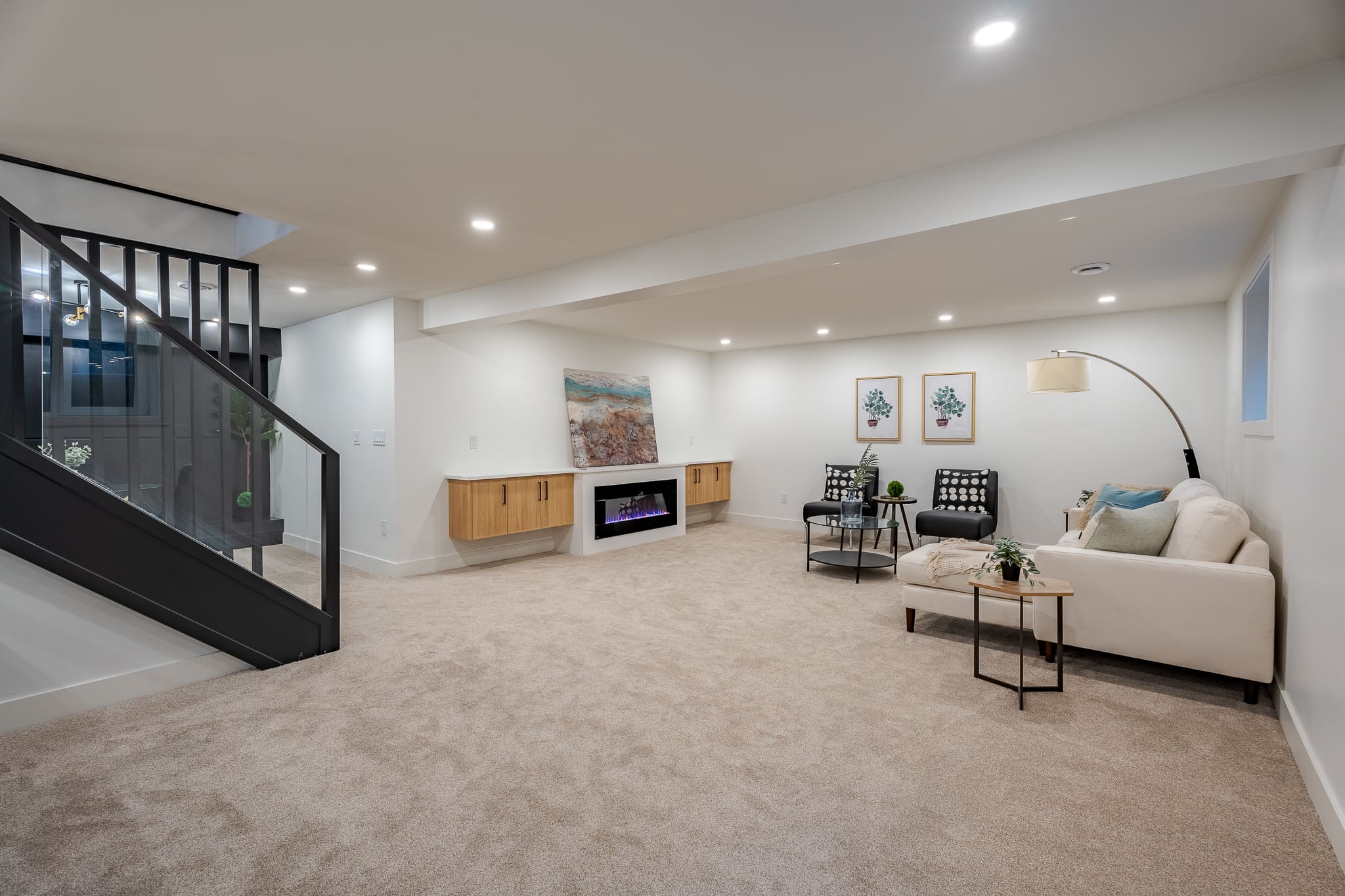 A living room with a couch, chair and television.