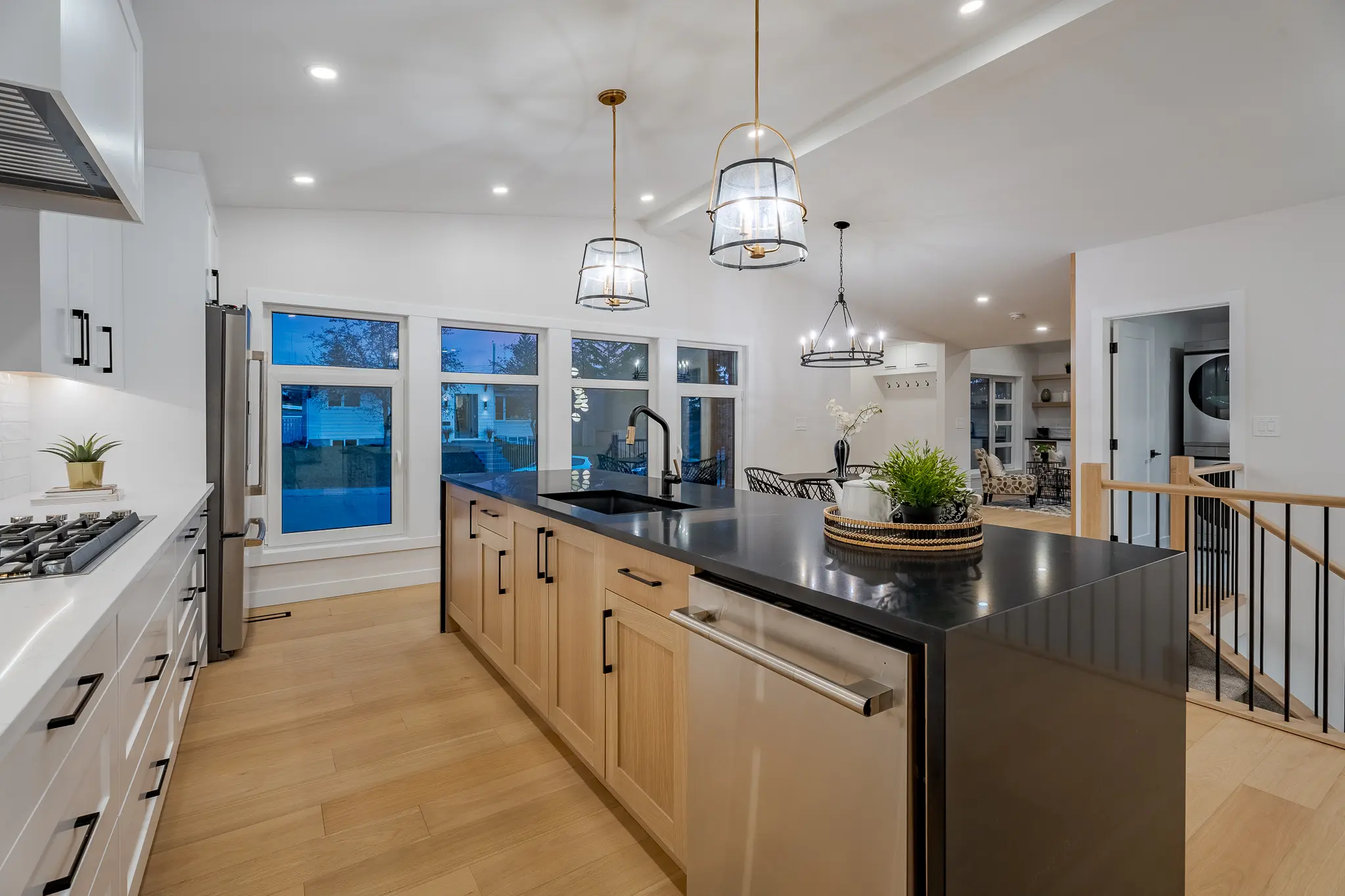 A kitchen with a large island and stainless steel appliances.