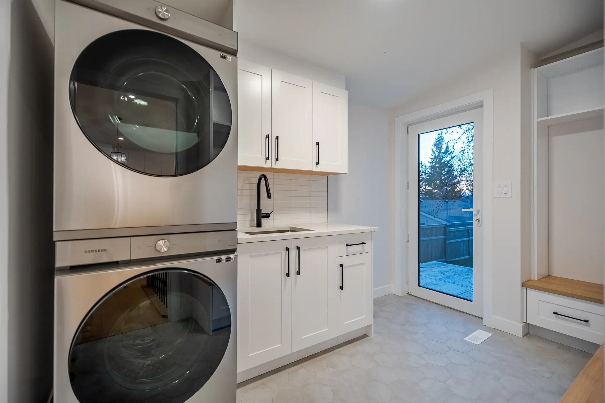 A room with two white cabinets and a sink.